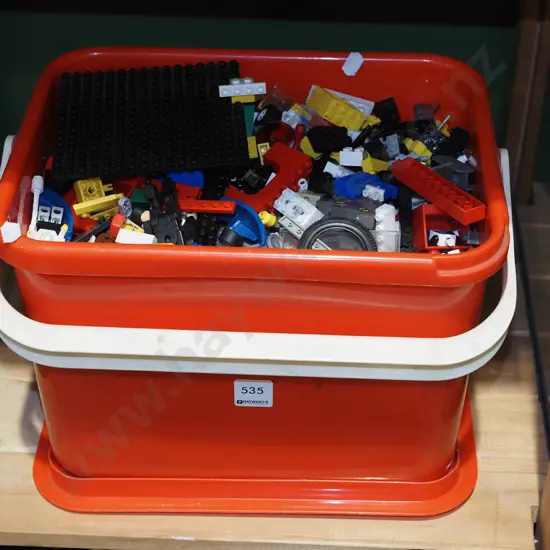 red plastic tub of Lego and Toro blocks