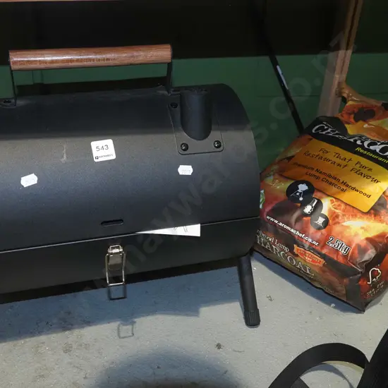 portable chimney bbq and bag of charcoal