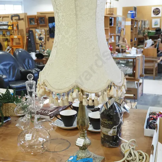 brass based table lamp with ill fitting shade