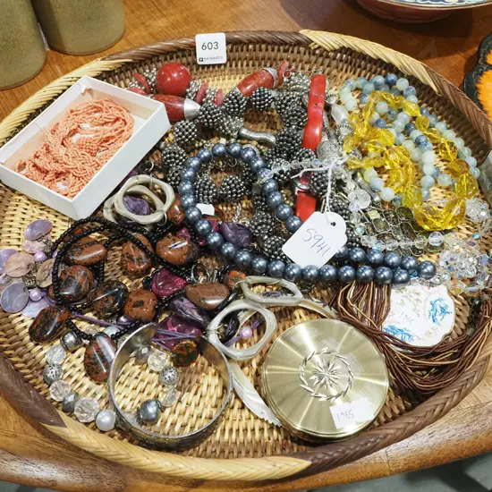 oval woven cane tray and costume jewellery