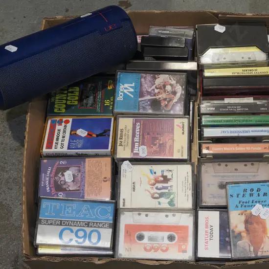 box of tape cassettes, UE Boom speaker