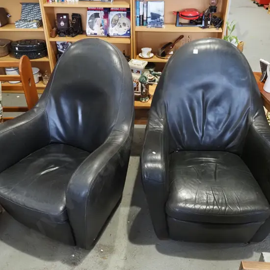 2x black leather armchairs -1 swivels, 1 does not