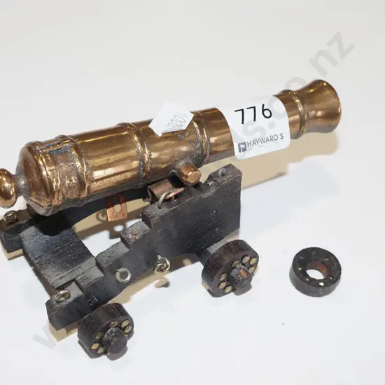 small brass cannon on wooden stand L130 (missing one wheel)