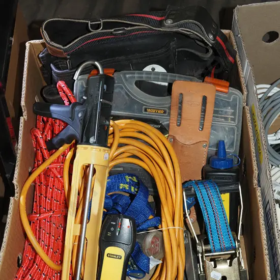 box; caulking gun, stud finder, rope, builder's belt etc