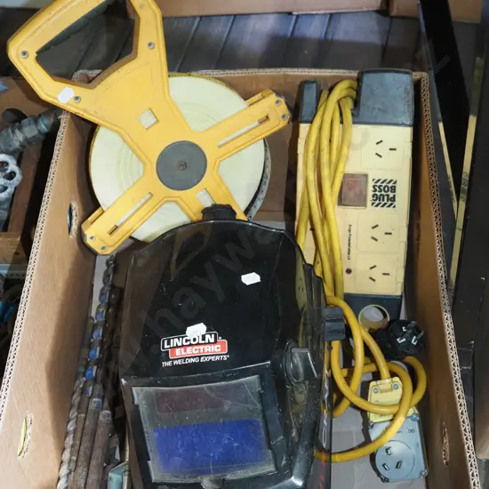 box; welder's mask, tape measure, multi board, drill bits