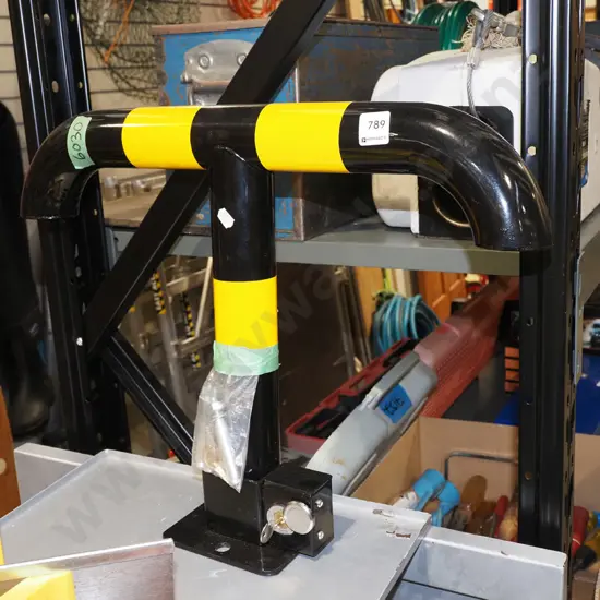small black and yellow drop down bollard H410 - key in office