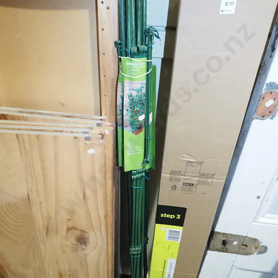 bundle of green plastic tomato cages