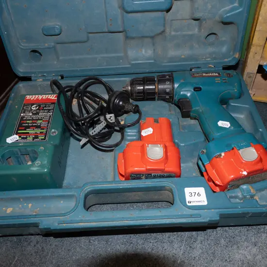 Makita battery powered drill, charger and case