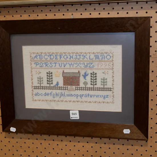 framed needlework sampler