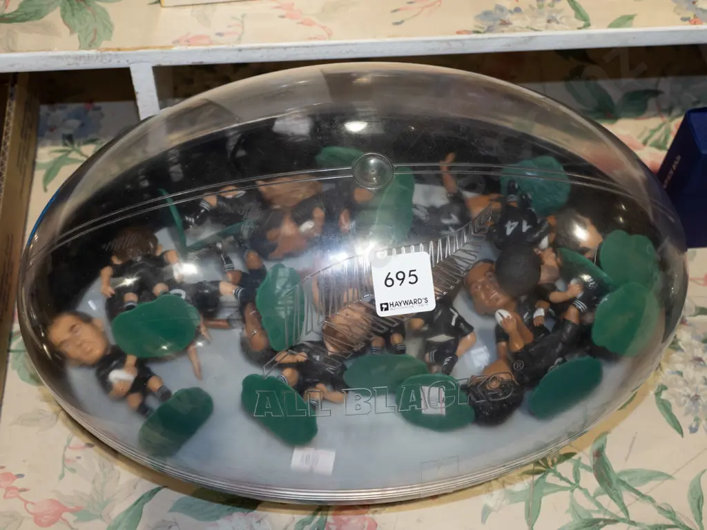 All Blacks rugby ball shaped case and various plastic All Black figurines Image 1++