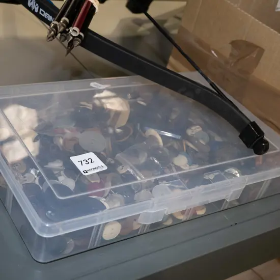 plastic container of various buttons