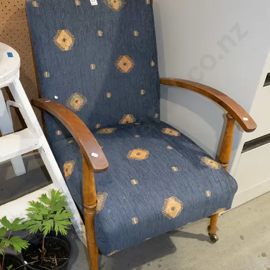 upholstered wooden armchair on casters