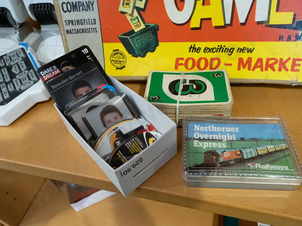 shelf; toy robot, check out board game, playing cards Image 1++