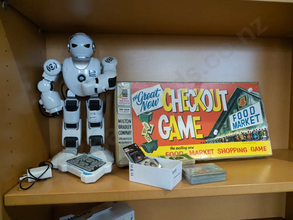 shelf; toy robot, check out board game, playing cards Image 1++