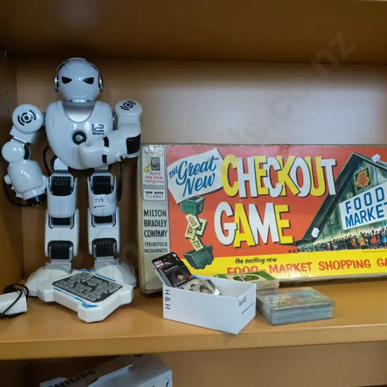 shelf; toy robot, check out board game, playing cards