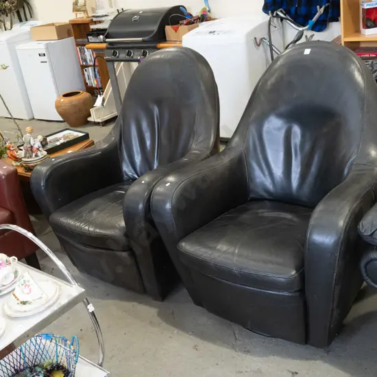 2x black leather armchairs - 1 rocking and swivel, 1 doesn't