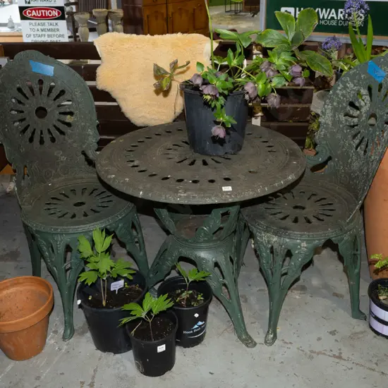 green painted cast alloy outdoor table and 2 chairs