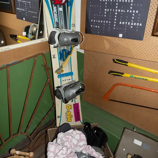 snowboard and box of accessories; jacket, boots, pants