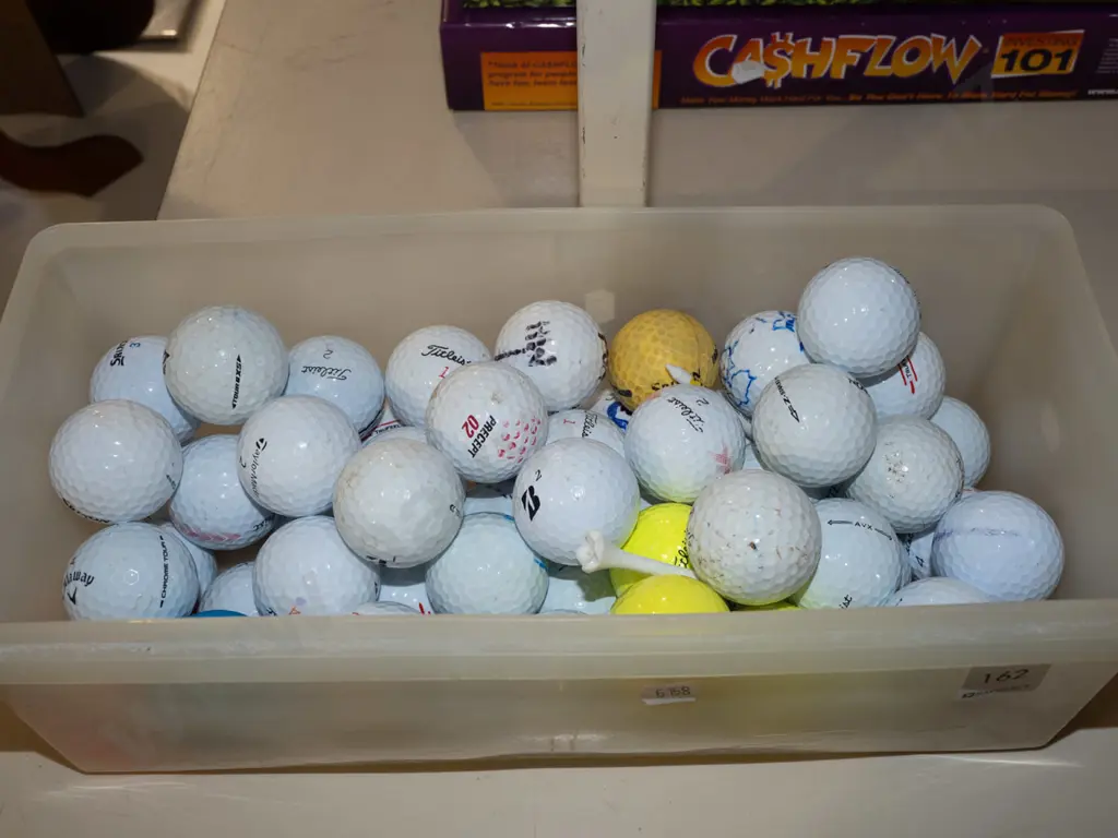 plastic tub of golf balls Image 1++
