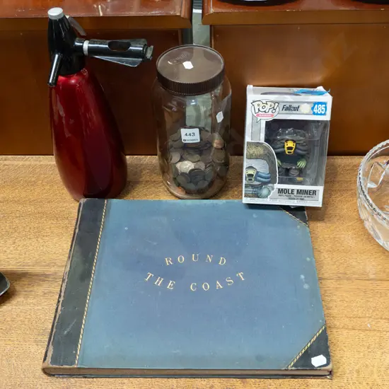 soda syphon, coins, Pop figurine, Round The Coast book