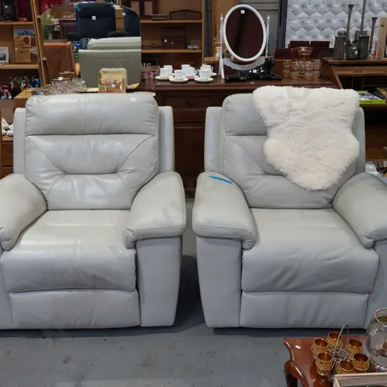 pair of cream/taupe leather upholstered reclining armchairs
