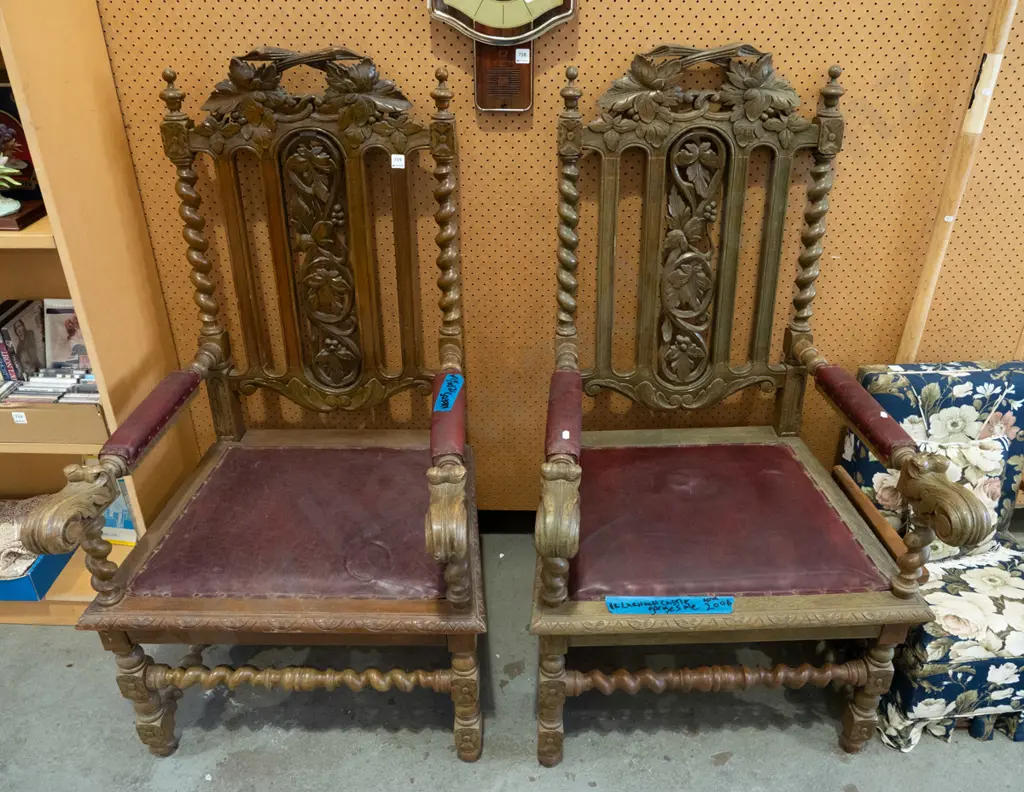 pair of ornately carved oak and red vinyl upholstered armchairs - purportedly ex Larnach Castle Image 1++