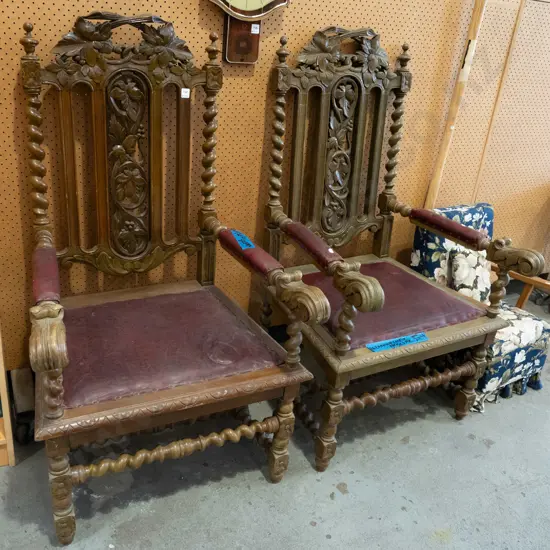 pair of ornately carved oak and red vinyl upholstered armchairs - purportedly ex Larnach Castle