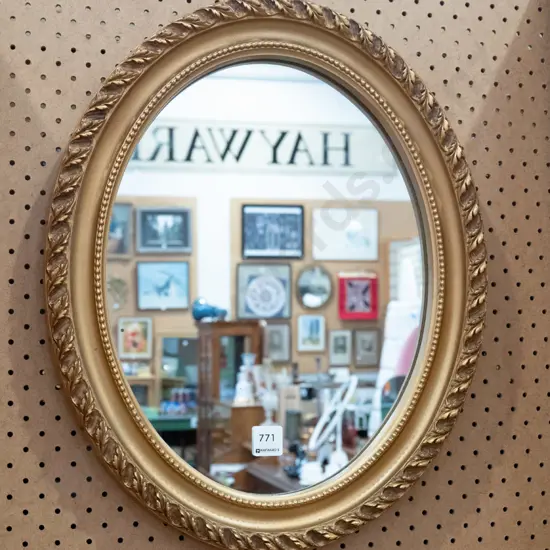 gilt framed oval wall mirror