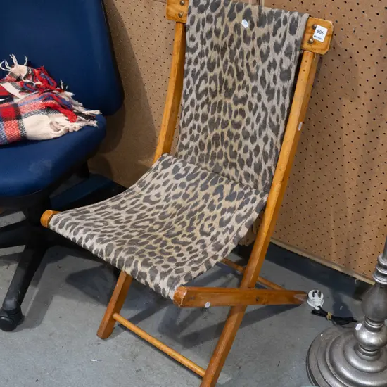 faux leopard skin upholstered foldaway chair