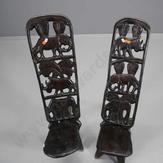 pair of African heavily carved elephant motif 2-piece collapsible chairs H-700 W-170 D-600