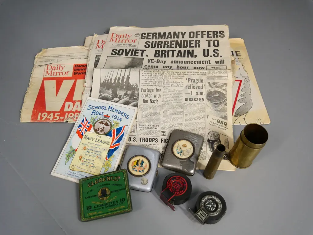 assorted militaria - WWI era cigarette cases & Otago navy League booklet, 2 shell casings, WWII news clippings, etc. Image 1++