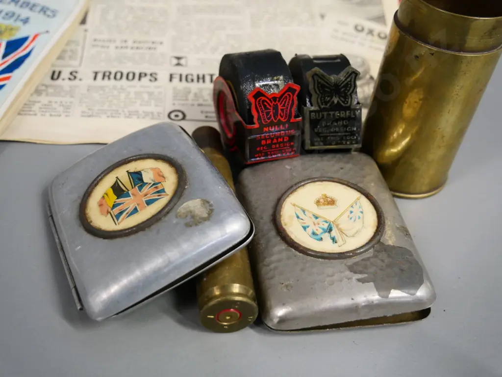 assorted militaria - WWI era cigarette cases & Otago navy League booklet, 2 shell casings, WWII news clippings, etc. Image 1++