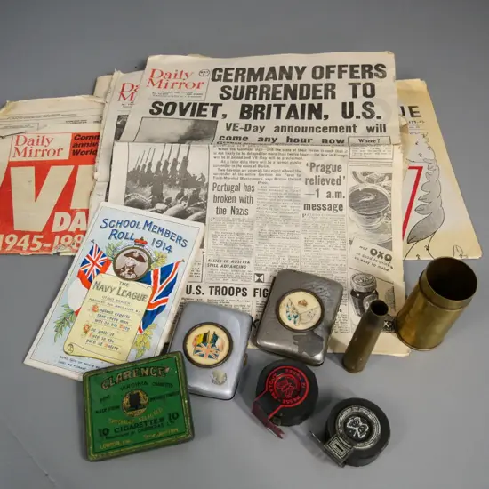 assorted militaria - WWI era cigarette cases & Otago navy League booklet, 2 shell casings, WWII news clippings, etc.