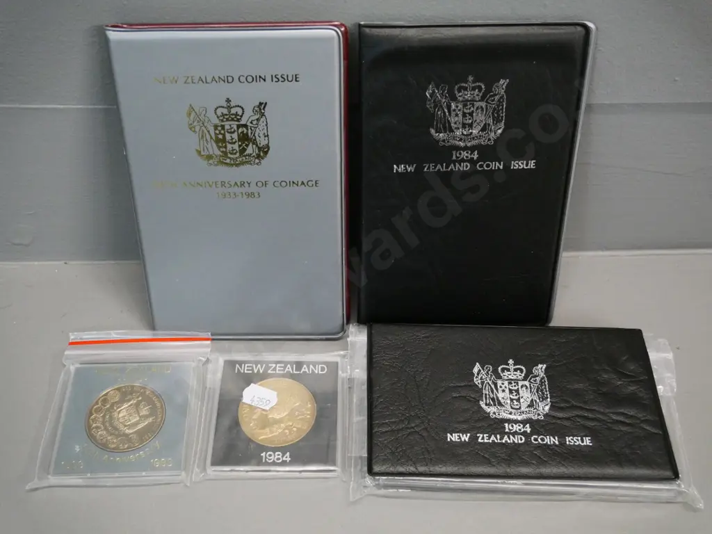 5 New Zealand collector coin items: 1983 collectors set,1984 cased proof set, 1984 collector set, 1983 and 1984 dollars Image 1++