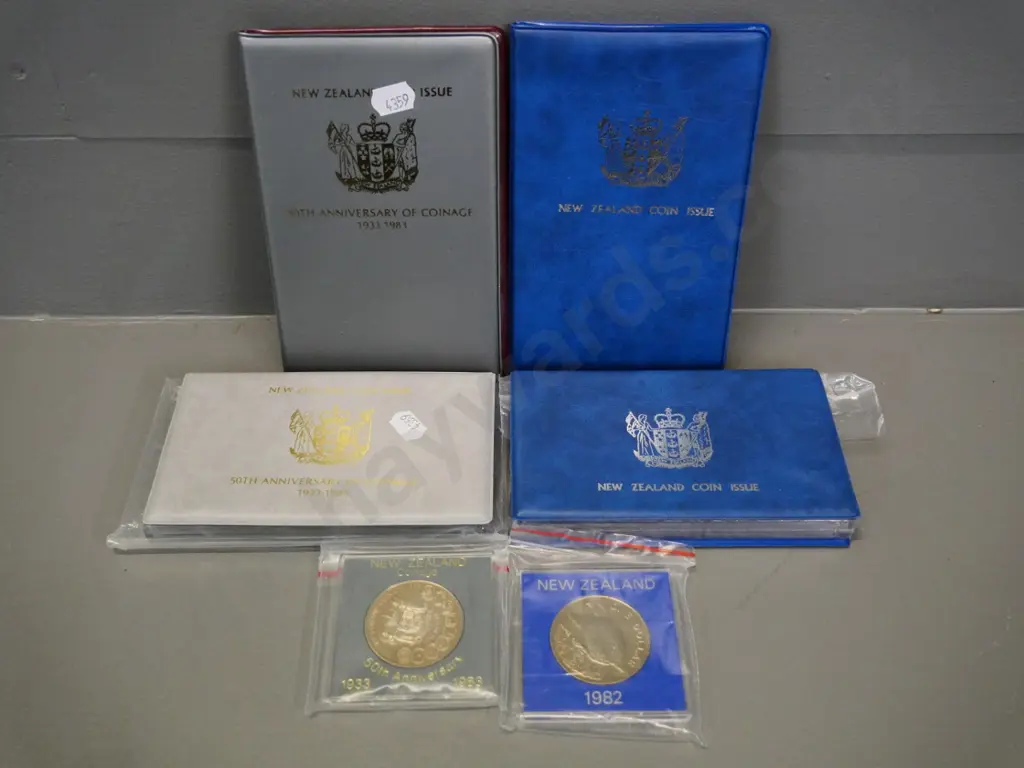 4 New Zealand collector coin sets: 1982 and 1983 cased proof sets and souvenir sets, 2 cased dollars Image 1++