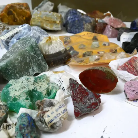 collection of minerals, rocks, rough and polished gemstone samples - with metal toolbox