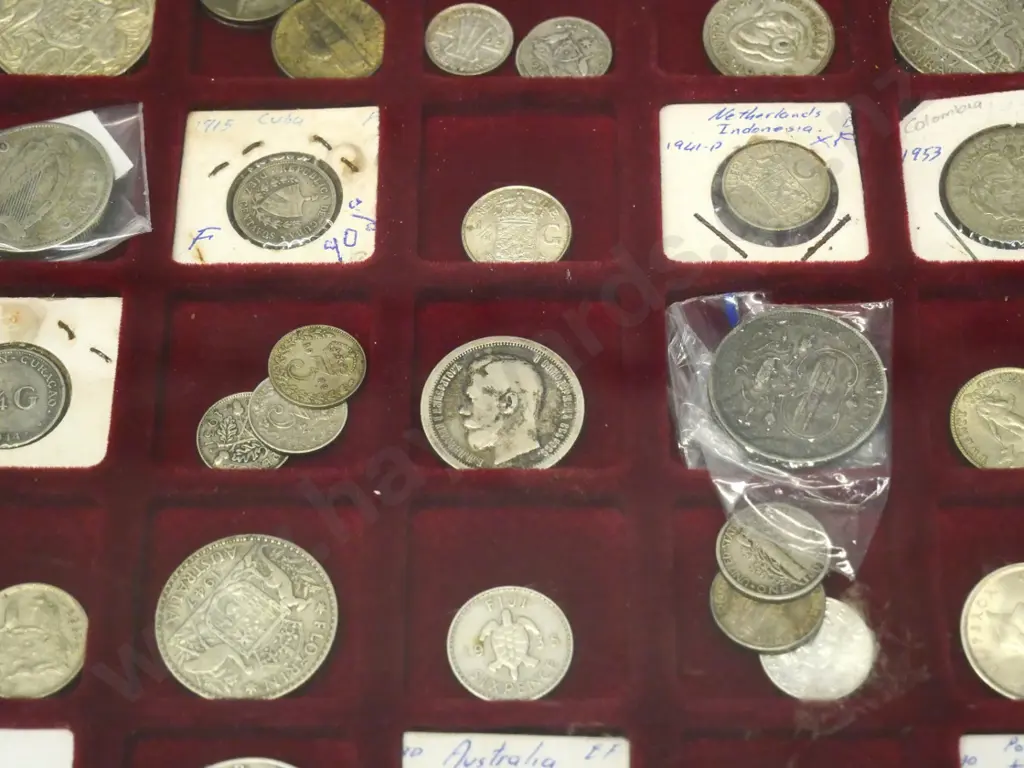 numerous overseas silver coins in plastic display case Image 1++
