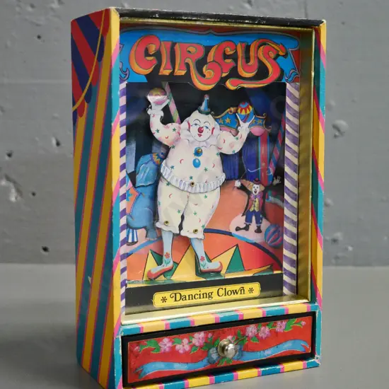 wind-up 'The Dancing Clown' music box with dancing clown figure plays It's A Small Small World tune