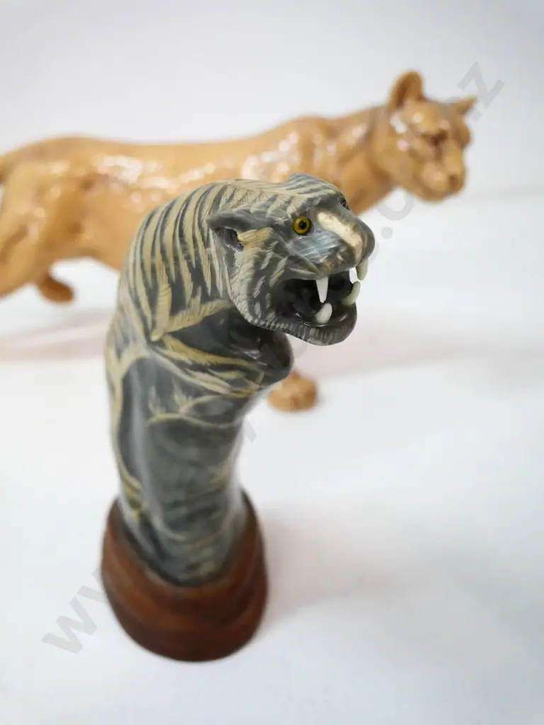porcelain mountain lion figure H-190 L-370, no maker's mark, and a carved horn tiger on wooden base Image 1++