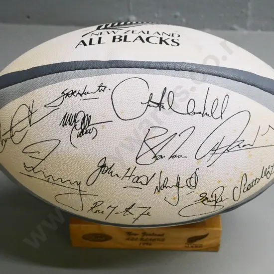 Gilbert All Blacks 1996 team souvenir rugby ball on wooden stand, printed team signatures