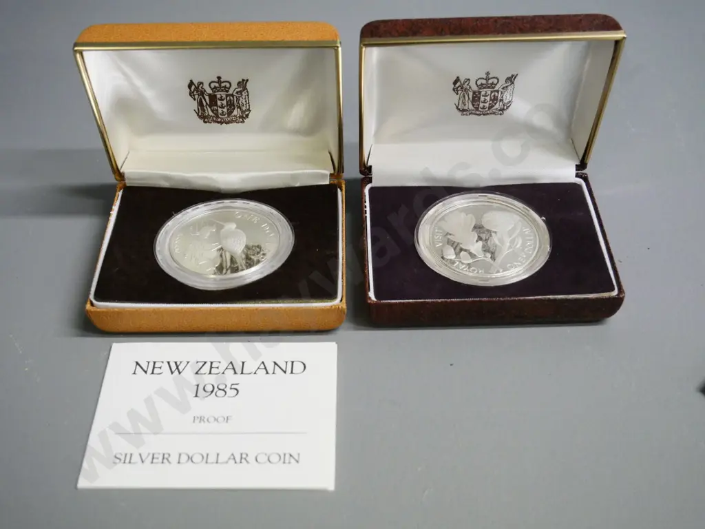 2 cased New Zealand silver dollars - 1981 Royal Visit and 1985 black stilt Image 1++