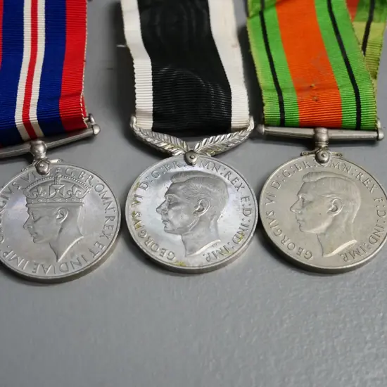 3 WWII military medals with ribbon - Defense medal, New Zealand medal, and a 1939-45 service medal