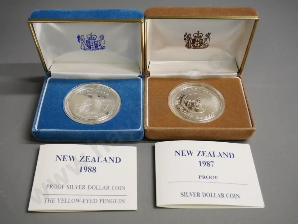 2 cased New Zealand silver dollars - 1987 National Parks and 1988 Yellow Eyed Penguin Image 1++