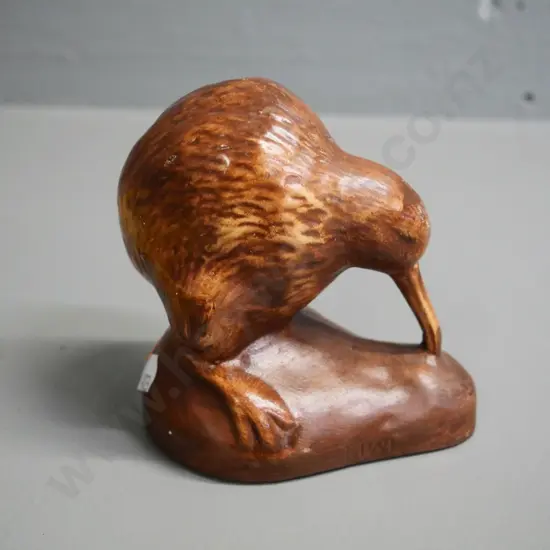 pottery kiwi figure H-100 and a tiki themed leather writing folder H-240 W-190