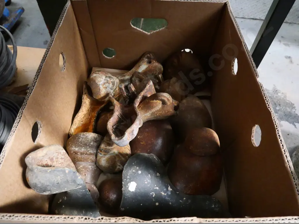 box of mismatched cast iron bath feet Image 1++