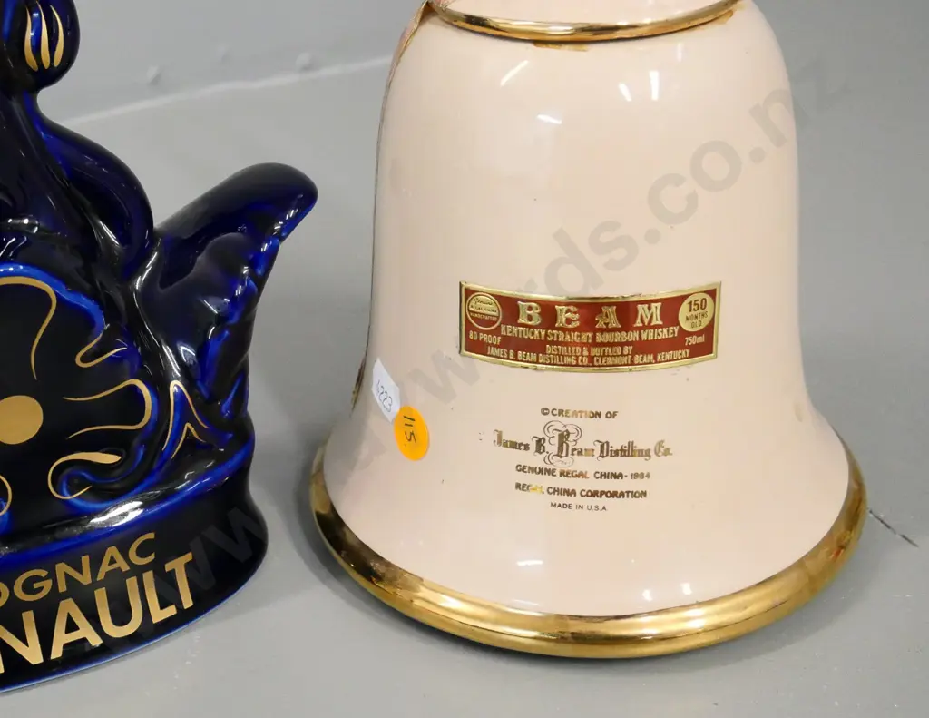 2 decanters - Limoges Renault branded cognac, repair to stopper & Jim Beam wind-up musical Noel bell (both empty) Image 1++
