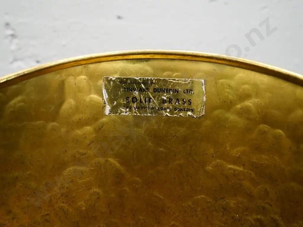 beaten brass coal scuttle with Tinware Dunedin label H-390 with handle down Image 1++
