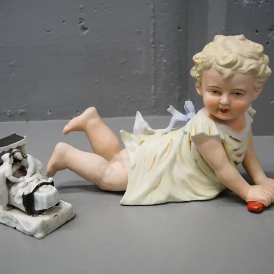 vintage soft porcelain figure H-180 L-280 and a small porcelain figure of a couple getting into bed H-180 L-280