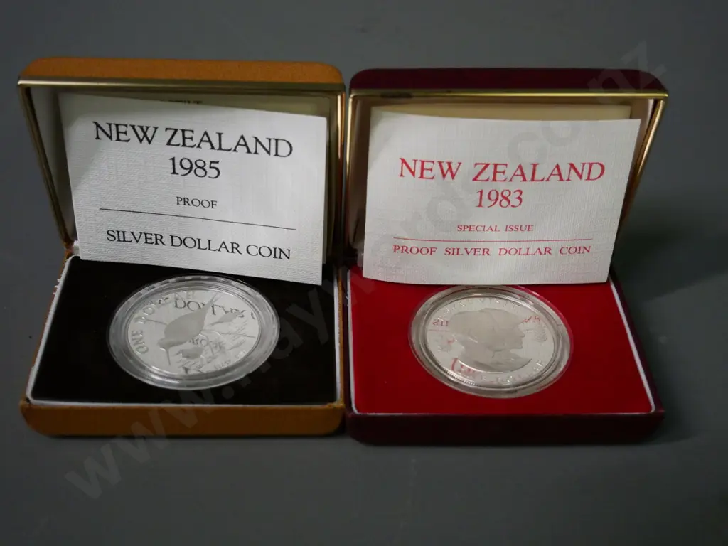 2 cased New Zealand silver dollars - 1983 Royal Visit & 1985 black stilt Image 1++