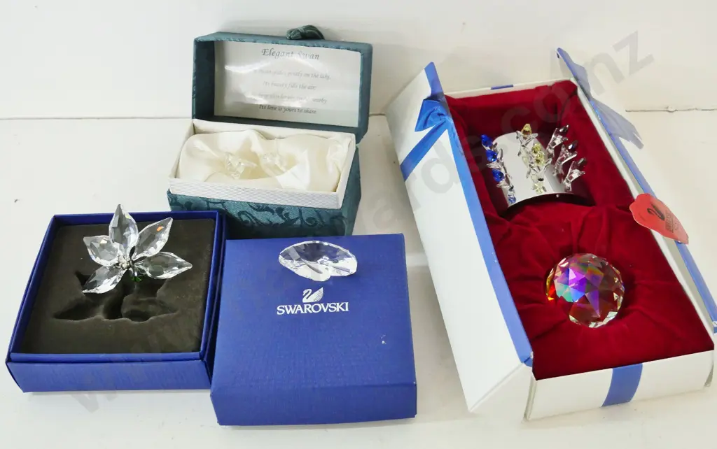 3 boxed Swarovski crystal ornaments and a boxed Chinese crystal swan Image 1++